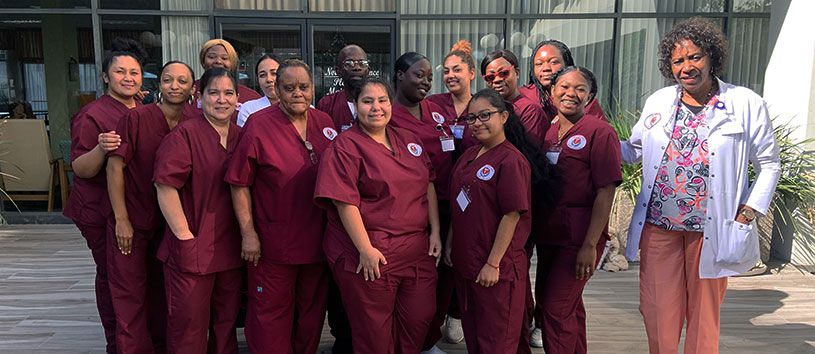 Healthcare Career College students standing outside together near Paramount campus.