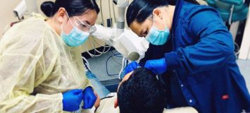 Dental Assistant students practicing on a patient.