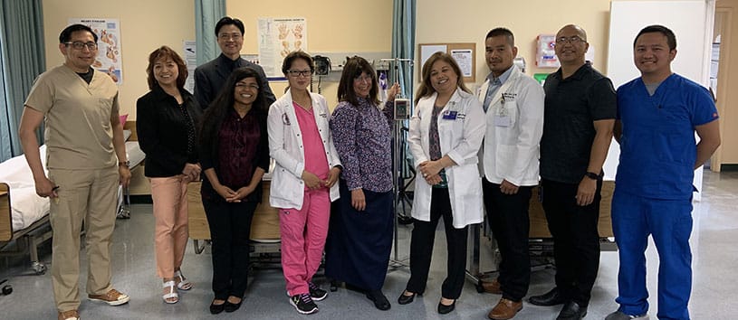 Group of Healthcare Career College instructors standing together in a lab setting in Paramount campus.