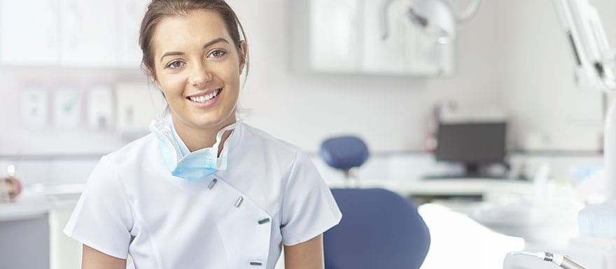 Smiling female Dental Assistant in a dental setting.