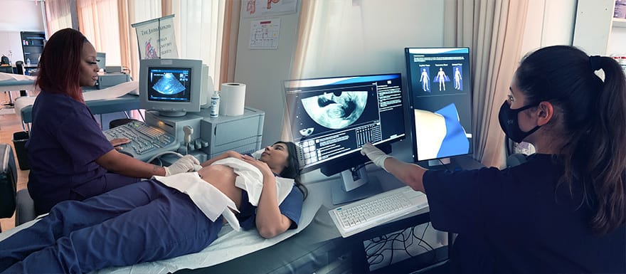 Healthcare Career College students practicing using an ultrasound machine.