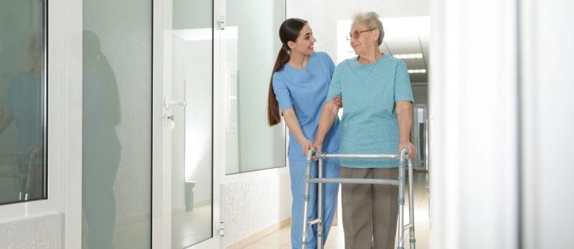 Physical Therapy Aide walking with patient.